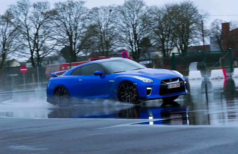 A car drifts on water during a drift day at Circuit de Mettet track in Belgium